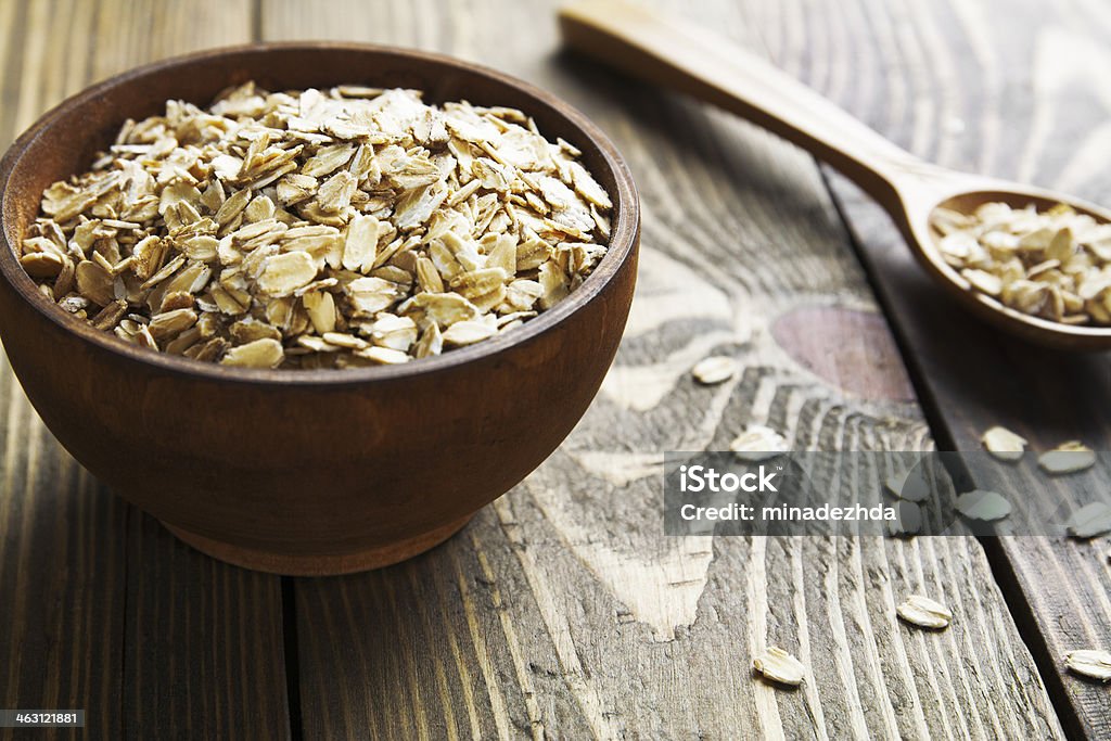 Oatmeal Oatmeal in a brown wooden bowl on the table Animal Stock Photo