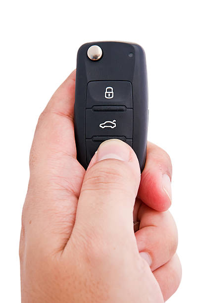 istock Man hand holding a garage door remote control 463123825