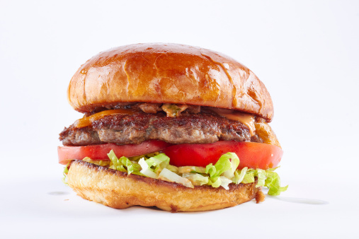 A classic hamburger with cheese, tomato, lettuce and a soft bun.