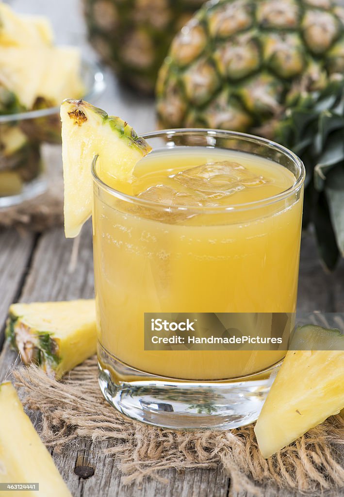 Fresh made Pineapple Juice Fresh made Pineapple Juice with Ice in a small glass Close-up Stock Photo