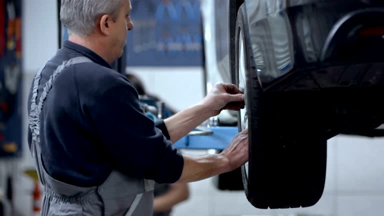 Mechanic Changing The Tire