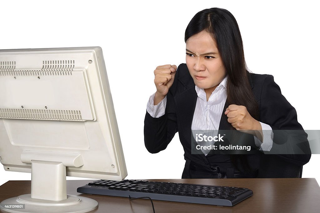 Businesswoman getting crazy in front of her laptop Businesswoman getting crazy in front of her laptop isolated over white background Adult Stock Photo