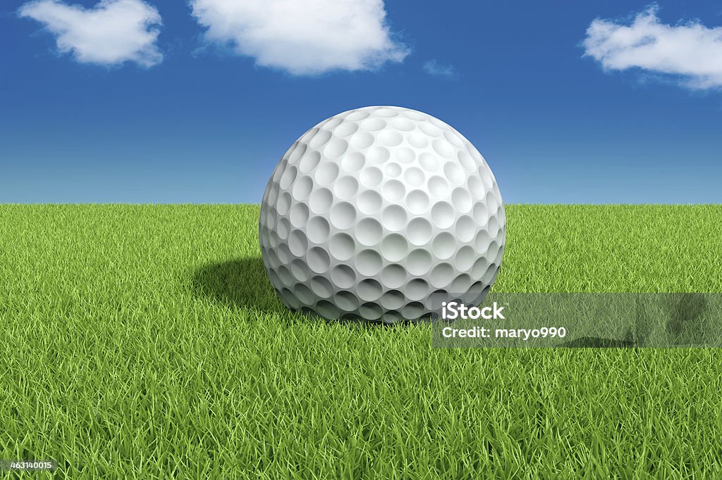 golf ball on green field Golf ball on green field with blue sky Blue Stock Photo