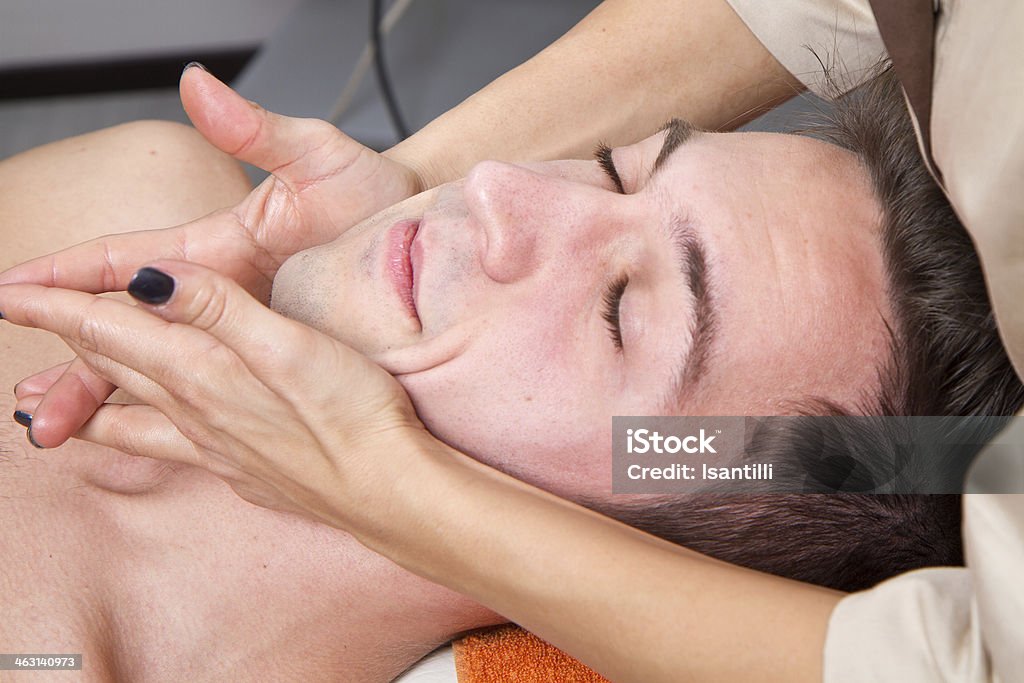 Man getting massage in thebeauty center a Man getting massage in thebeauty center Adult Stock Photo