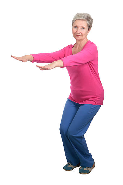istock Elderly woman tracksuit doing squats 463144033