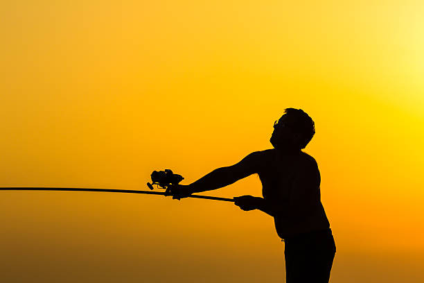 istock Fisherman's silhouette on the beach 463144177