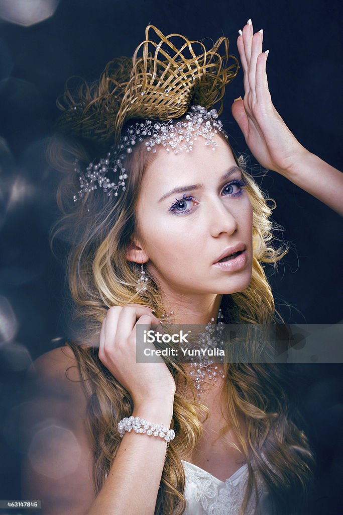 beauty young snow queen in fairy flashes beauty young snow queen in fairy flashes with crown on her head Adult Stock Photo