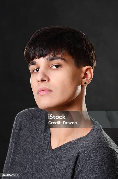 Portrait Of Handsome Dark Hair Teenager On Isolated Black Background Stock Photo - Download Image Now