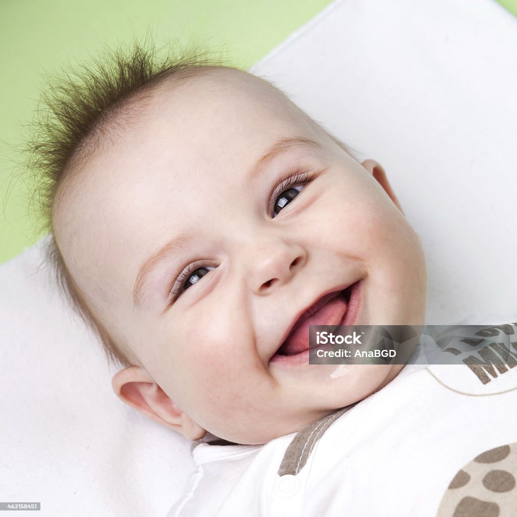 Silly baby Close up of adorable 6 months old baby laughing and sticking out its tongue Baby - Human Age Stock Photo