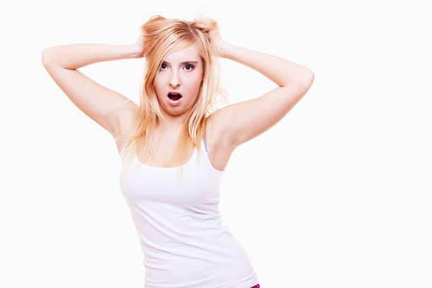 istock Stress. Young woman frustrated pulling her hair on white 463160113