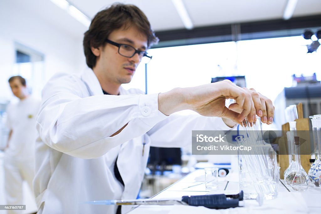 Young male researcher carrying out scientific research in a lab Young male researcher carrying out scientific research in a lab (shallow DOF; color toned image) Adult Stock Photo