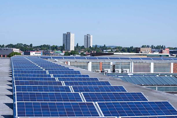 Commercial Solar Panels Solar photovoltaic panels on a commercial building solar panels on the roof of building in a city stock pictures, royalty-free photos & images