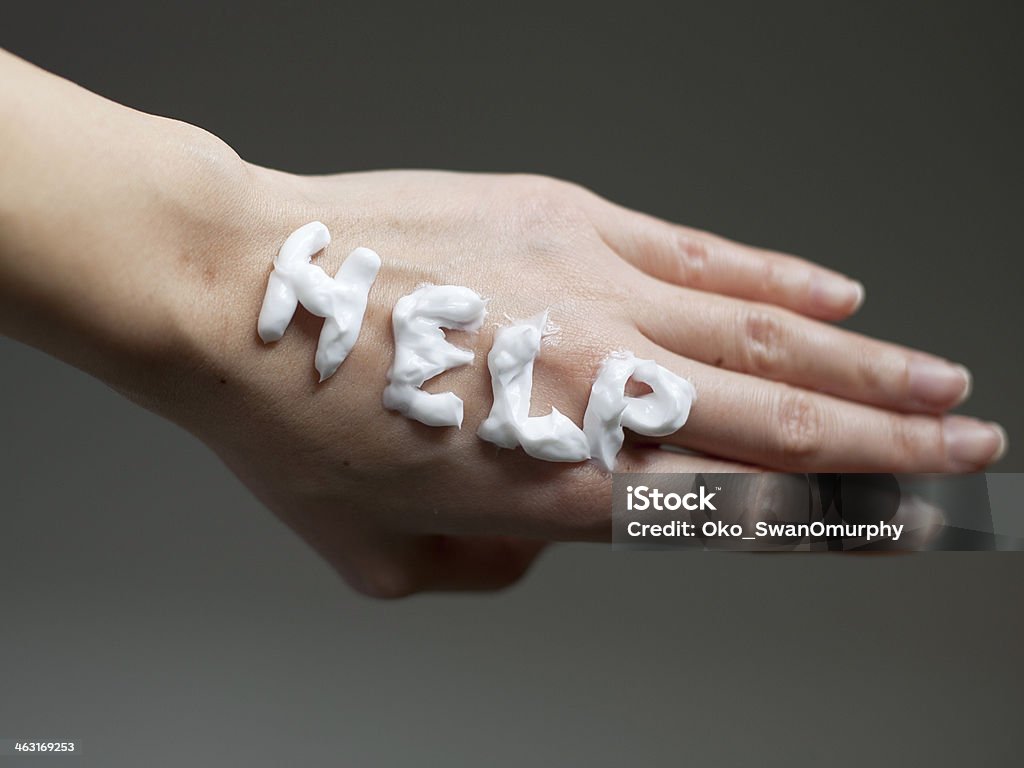 Help Hand care for dry skin, written HELP on a dry skin with cream Dry Stock Photo