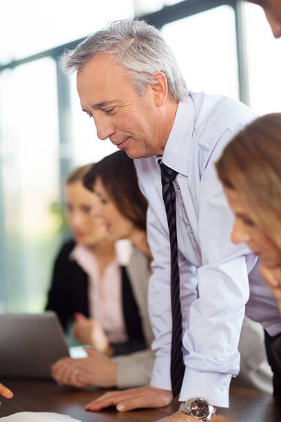 istock Business man leaning over at the meeting table 463173431