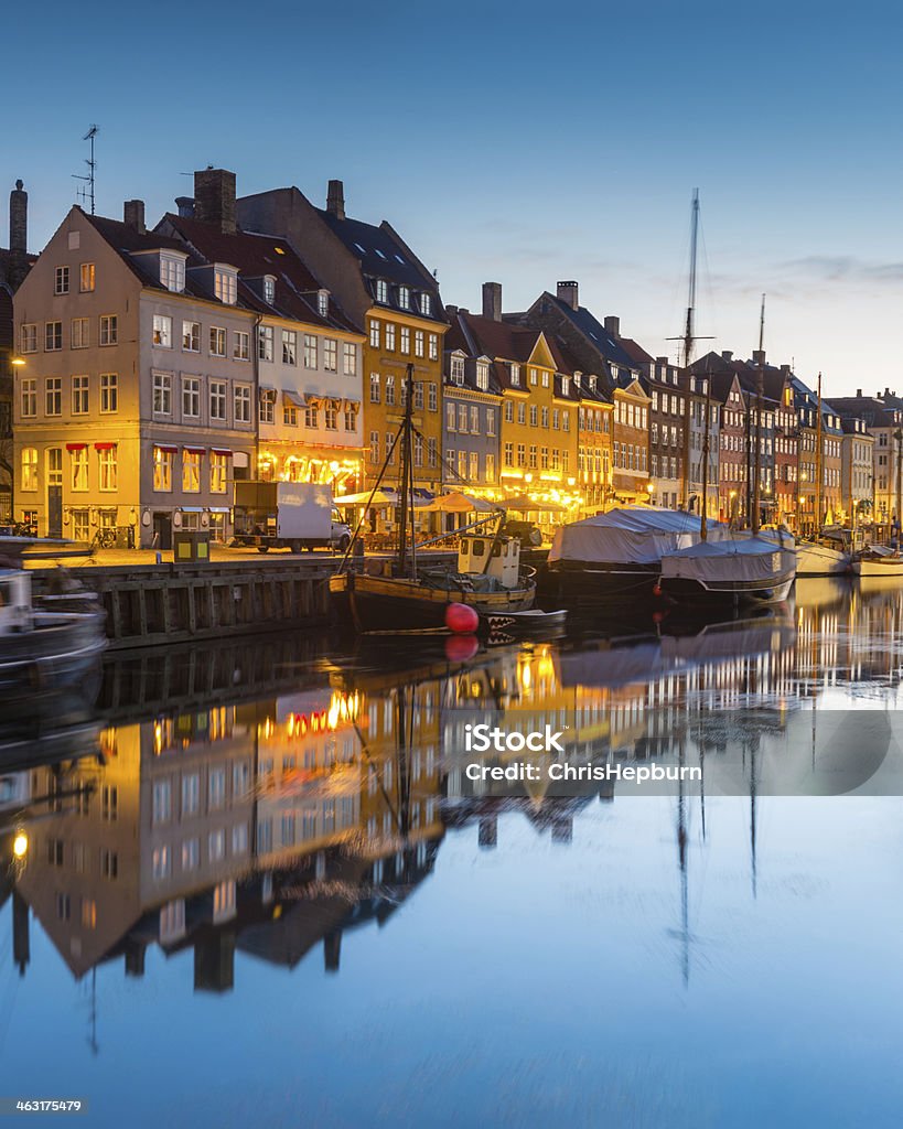 Nyhavn, Copenhagen, Denmark Early morning at Nyhavn, an iconic waterfront street in Copenhagen, Denmark, Europe. Blue Stock Photo
