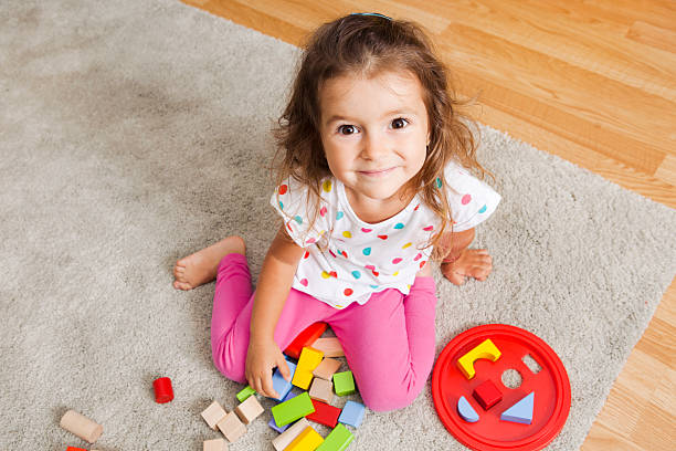 istock Preschooler girl playing with blocks 463175561