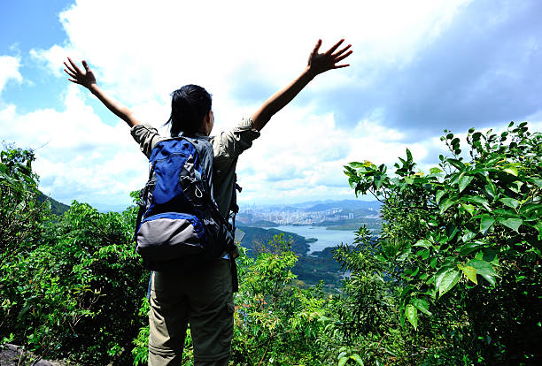 istock woman hiker stand mountain peak with arms open 463181861