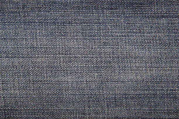 The worn blue jeans, a textile background.