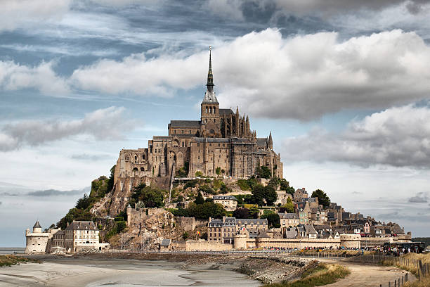 istock Mont Saint Michael at low tide under a cloudy sky 463182297