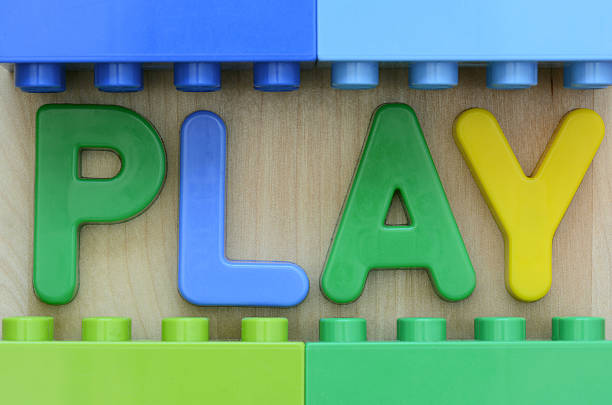 Close up of PLAY word in plastic letters surrounded by plastic toy blocks