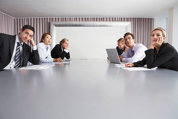 business people sitting in conference room - 無聊 個照片及圖片檔