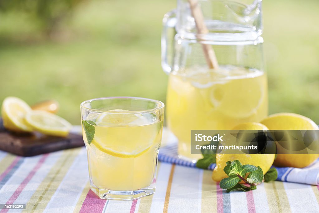 Glass of homemade lemonade Glass of homemade lemonade in a garden table Lemonade Stock Photo