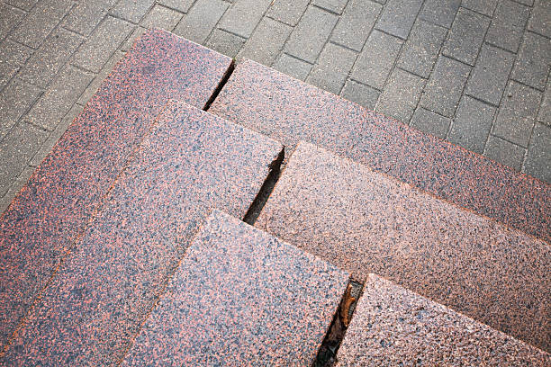 istock Stairs made of red granite on gray pavement 463192547