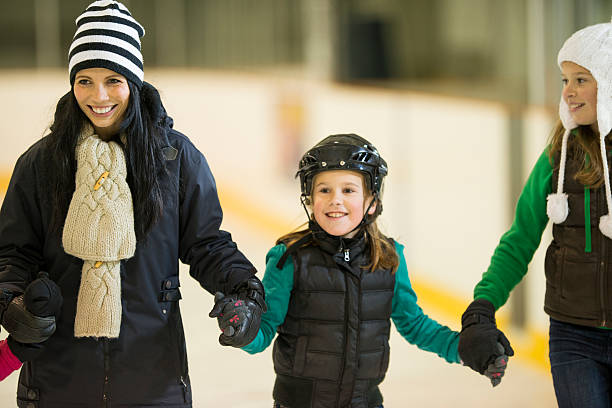 istock Mother and daughters having fun on skating rink 463213111