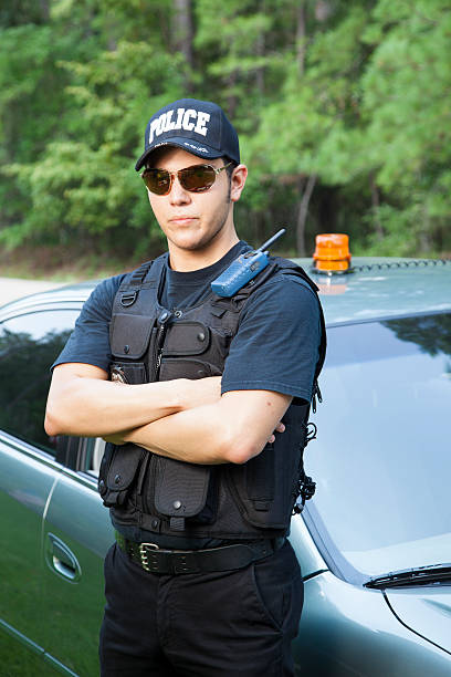 istock Law:  Latin policeman waits by his vehicle. 463213373