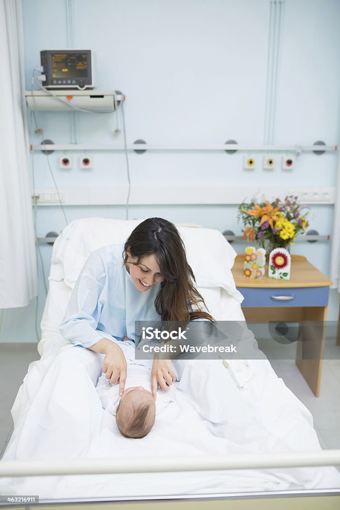 Donna giocando con un neonato - Foto stock royalty-free di Ospedale