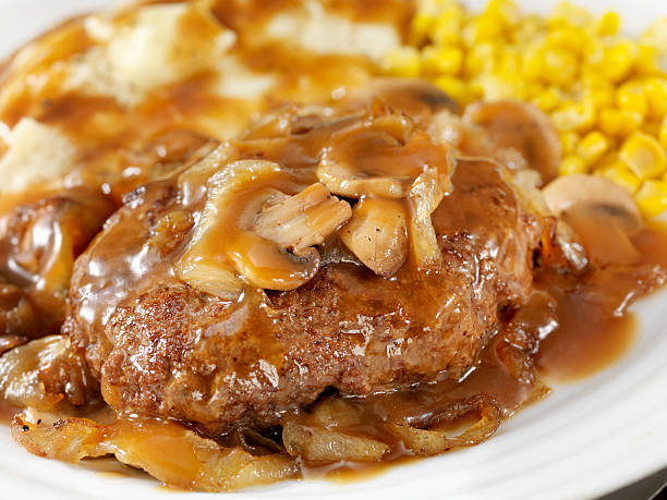 Salisbury Steak Salisbury Steak Topped with Sauteed Mushrooms and Onions, Mashed Potatoes and Corn on the side and topped with Gravy. - Photographed on Hasselblad H3D2-39mb Camera salisbury steak stock pictures, royalty-free photos & images