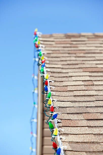 istock LED Christmas Lights Clipped to House Roof 463219669