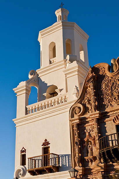 Mission San Xavier Del Bac Mission San Xavier del Bac is an historic Spanish Catholic mission located on the Tohono O'odham Nation San Xavier Indian Reservation. The mission was founded in 1692 by Padre Eusebio Kino. The mission was named for Francis Xavier, a Christian missionary. The original building was located north of the present church and served until it was razed in 1770 during an Apache raid. The mission that replaced the original was built between 1783 and 1797. It is the oldest European structure in Arizona. Today the mission is a popular tourist destination and gets about 200,000 visitors each year. It was listed in the National Register of Historic Places on October 15, 1966. Mission San Xavier del Bac is near Tucson, Arizona, USA. jeff goulden church stock pictures, royalty-free photos & images