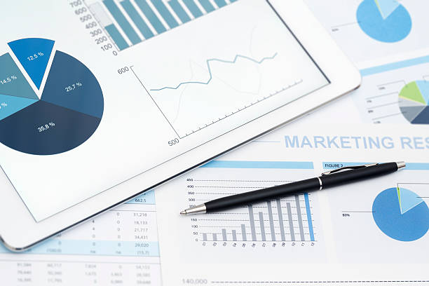 istock Tablet computer and stock market reports with pen 463222069