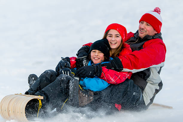 istock Family Fun in the Winter Snow 463225319