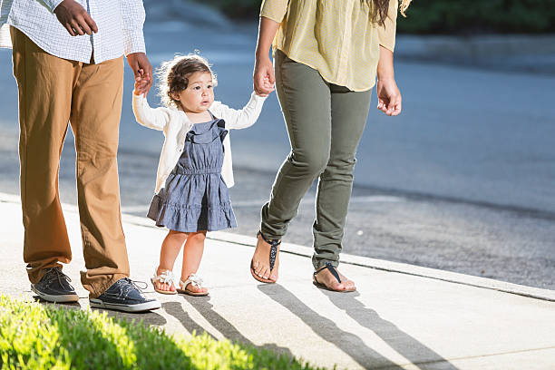 латиноамериканцы малыш ходьба с родителями - young family family with one child walking learning стоковые фото и изображения