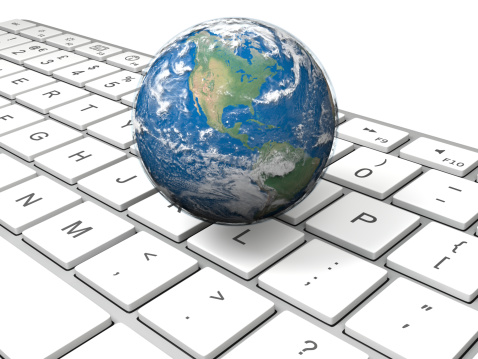 Realistic model of planet Earth hovering above computer keyboard. Elements of this image furnished by NASA.