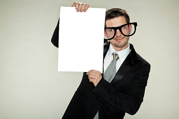 istock businessman is holding an empty card 463234747