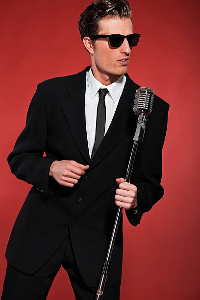 istock Retro fifties singer with vintage microphone and sunglasses. 463237939