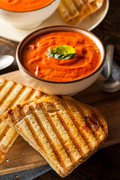 Grilled Cheese Sandwich with Tomato Soup Grilled Cheese Sandwich with Creamy Tomato Basil Soup tomato soup stock pictures, royalty-free photos & images