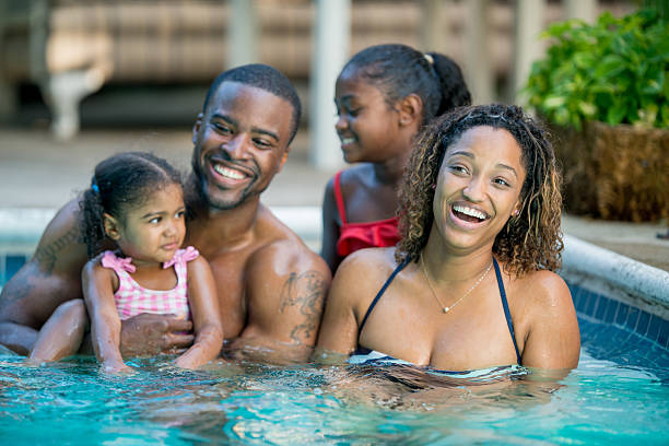 istock family having fun in swimming pool 463243165