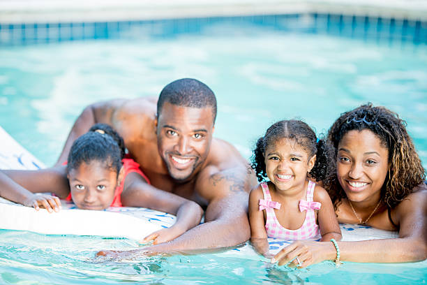 istock family having fun in swimming pool 463243233