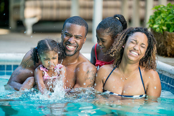 istock family having fun in swimming pool 463243957
