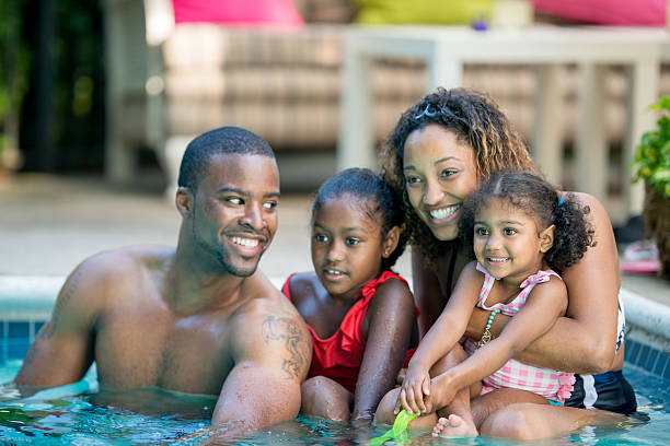 istock family having fun in swimming pool 463243983