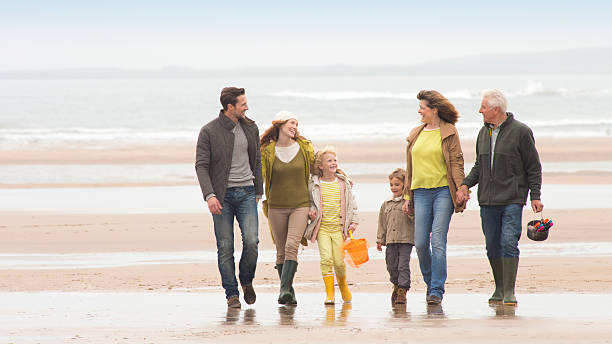 istock Family Walking on Beach 463243989