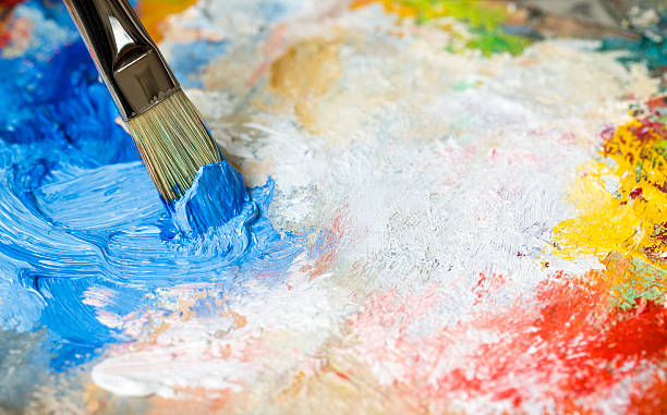 istock Paintbrush with blue oil paint on a classical palette 463258731