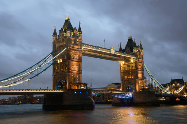 istock Illuminated Tower Bridge London under heavy rain clouds at dusk 463258741