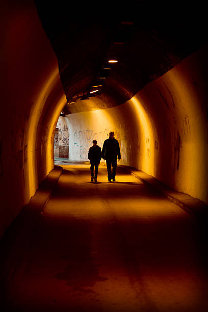 istock Man and Boy in a Tunnel 463258777
