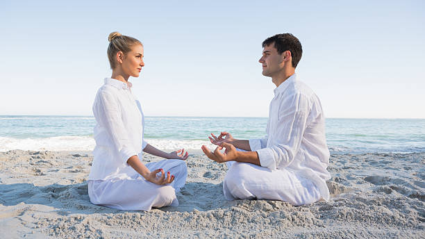 istock Peaceful couple sitting in lotus position facing each other 463259291