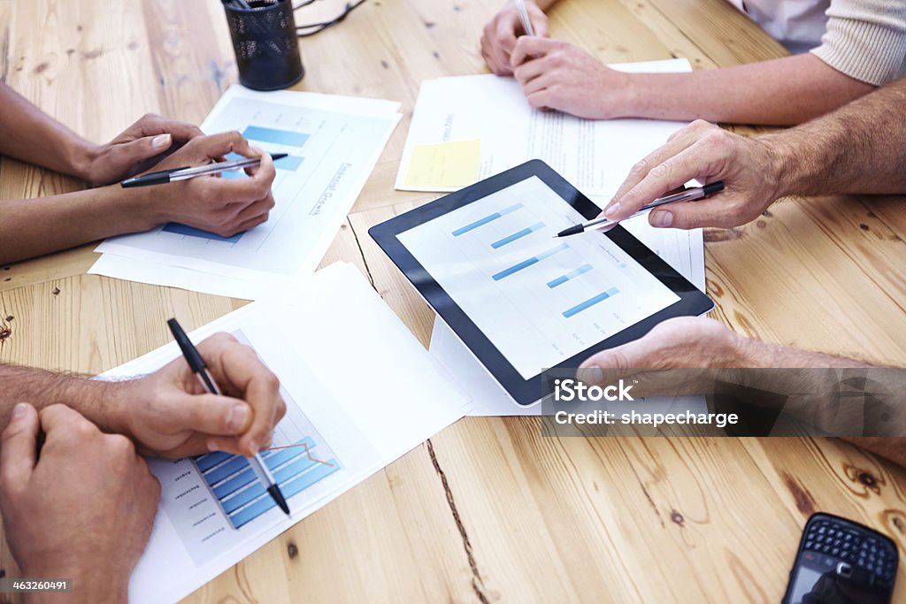 Team business discussion using a tablet Cropped view of businesspeoples' hands as they have a meeting while making use of a digital tablet Business Meeting Stock Photo